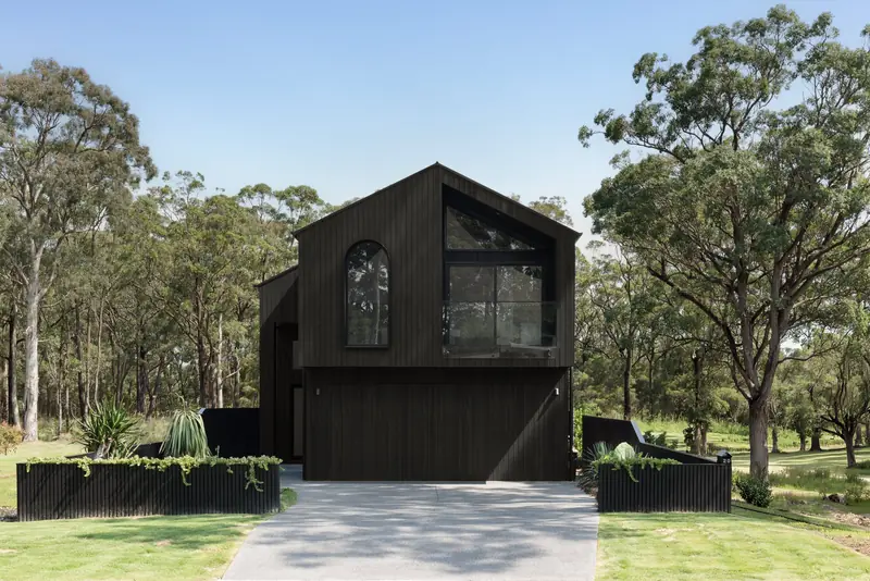 After: the black timber-clad Huskisson Duplex by CKS Projects on the same block